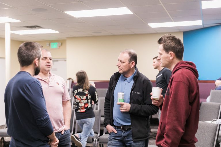 Group of men talking at church event